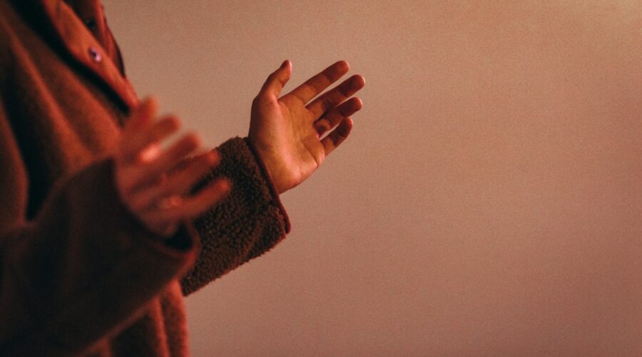 person in red sweater wearing silver ring