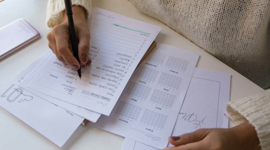 person writing on white paper