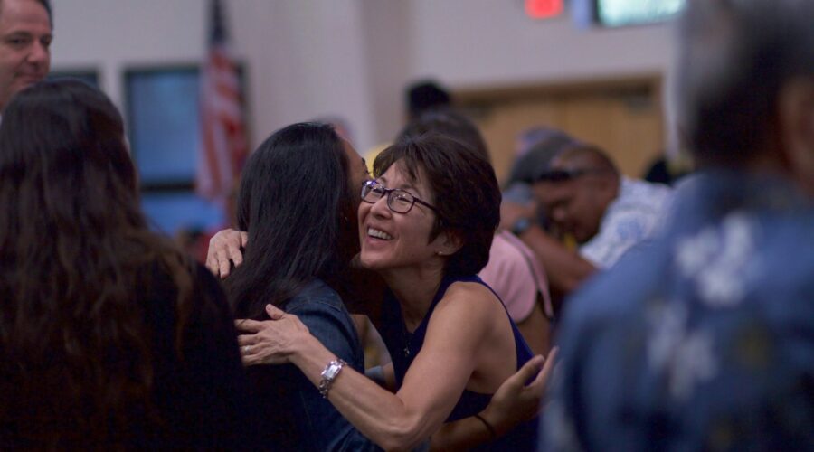 selective focus photography of two women hugging