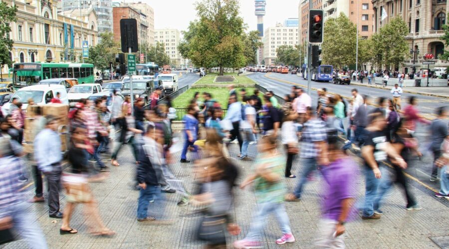 timelapse photo of people passing the street