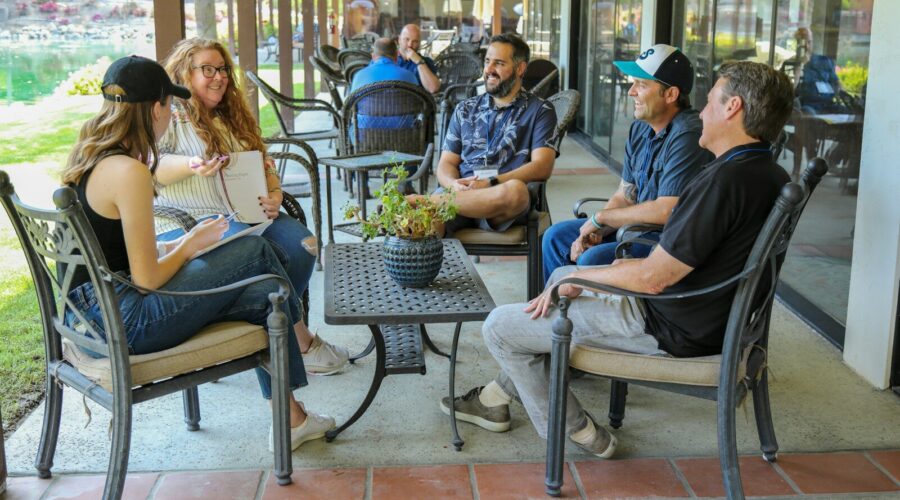 people sitting on gray metal chairs during daytime
